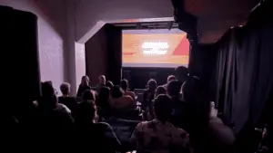 a group of people watch a film in a small cinema