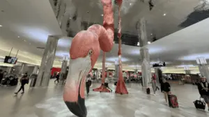 a giant flamingo sculpture in the center of the airport