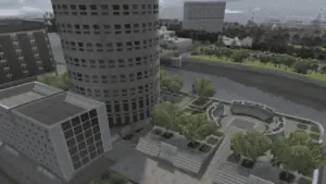 Aerial view of a downtown area with skate ramps at the base of a tall building