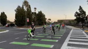cyclists ride expanded green lanes at sunset