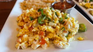 scrambled eggs on a plate with peppers