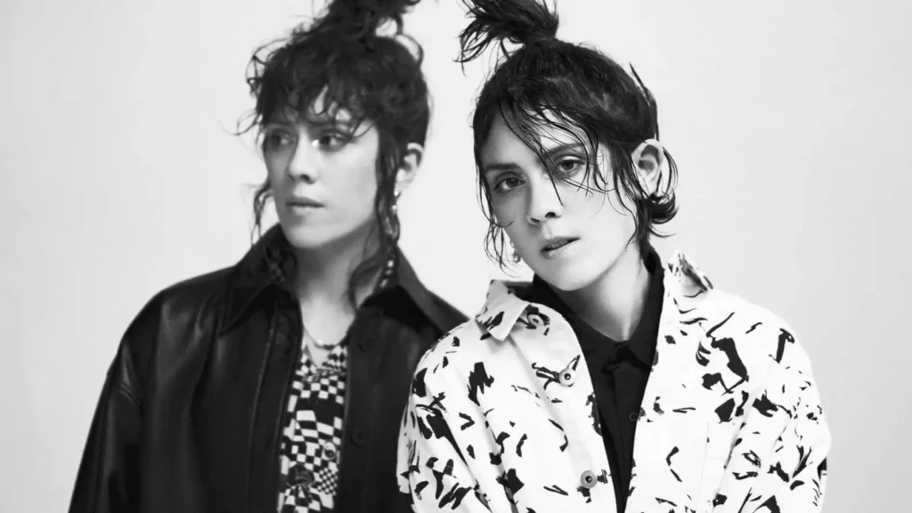 tegan and sara in black and white posing without smiling