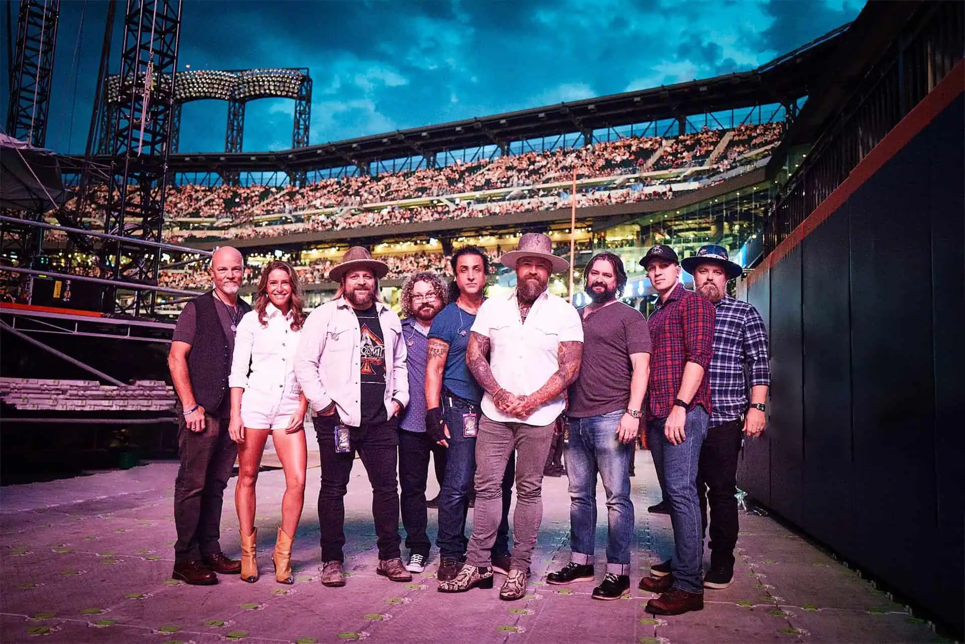 The Zac Brown Band stands in front of a full arena