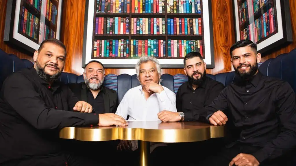 The Gipsy Kings posing in a dining booth