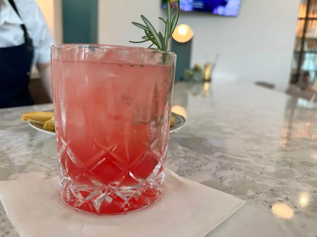 a pink cocktail in a small glass