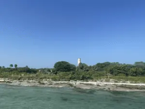 An island with a lighthouse and tons of greenery