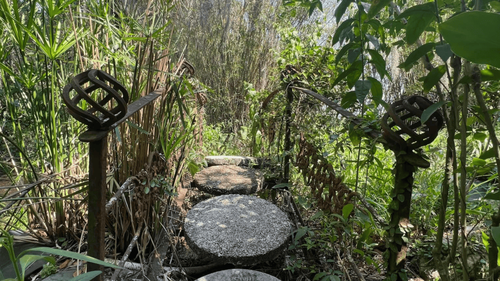 a forest area with circular concrete blocks making a path through