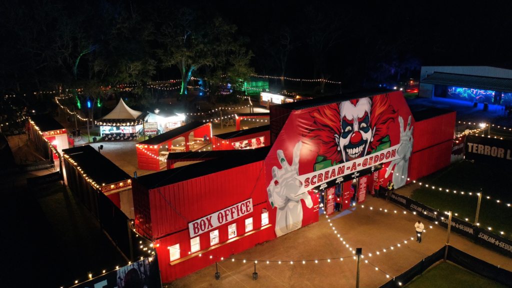 Aerial view of Scream A Geddon Horror Park with large red entrance with a clown face over the door