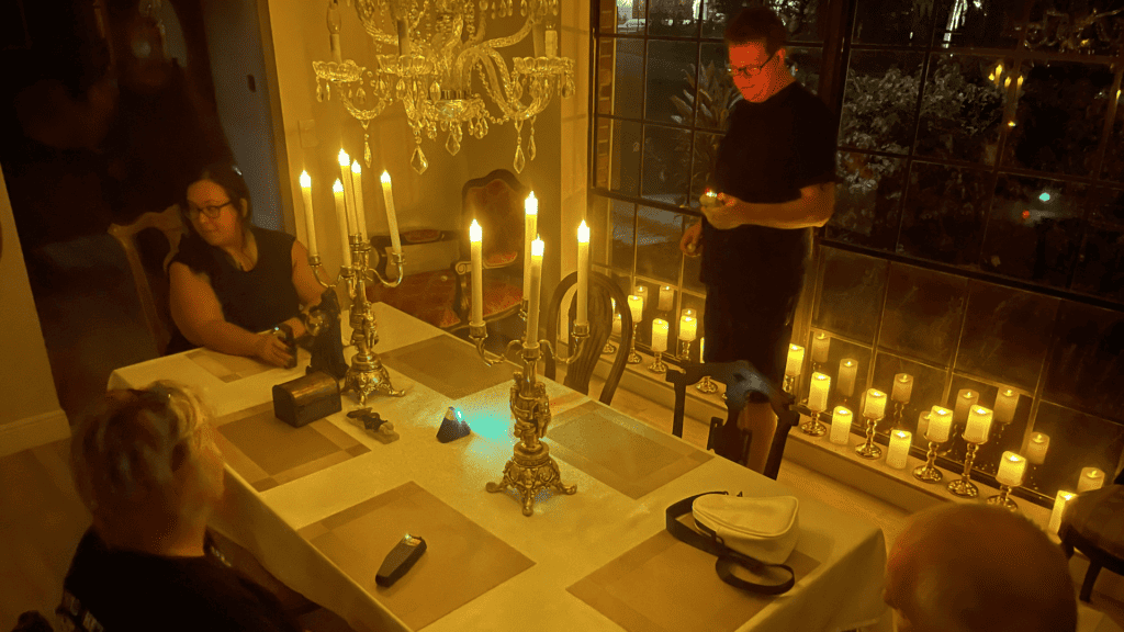 Seance set up around a dining table with candles all around