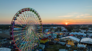 Aerial view of a large state fair with a huge Ferris wheel
