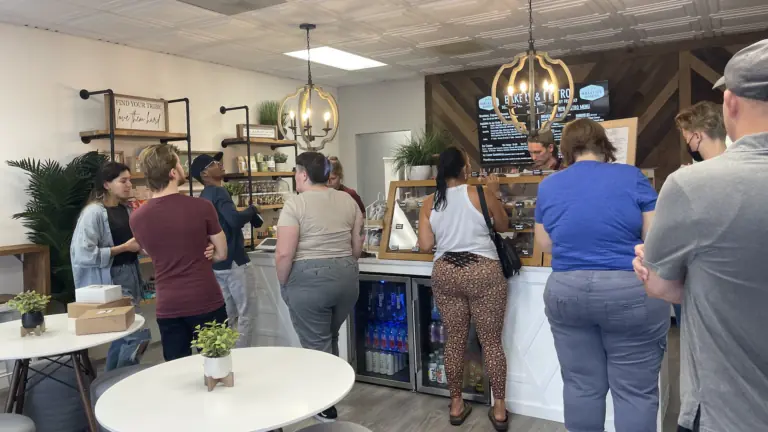 inside a bakery with a huge line