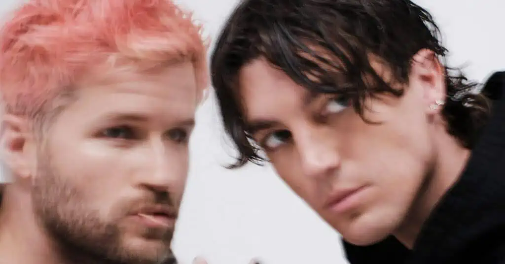 a closeup blurry photo of two of the LANY band members