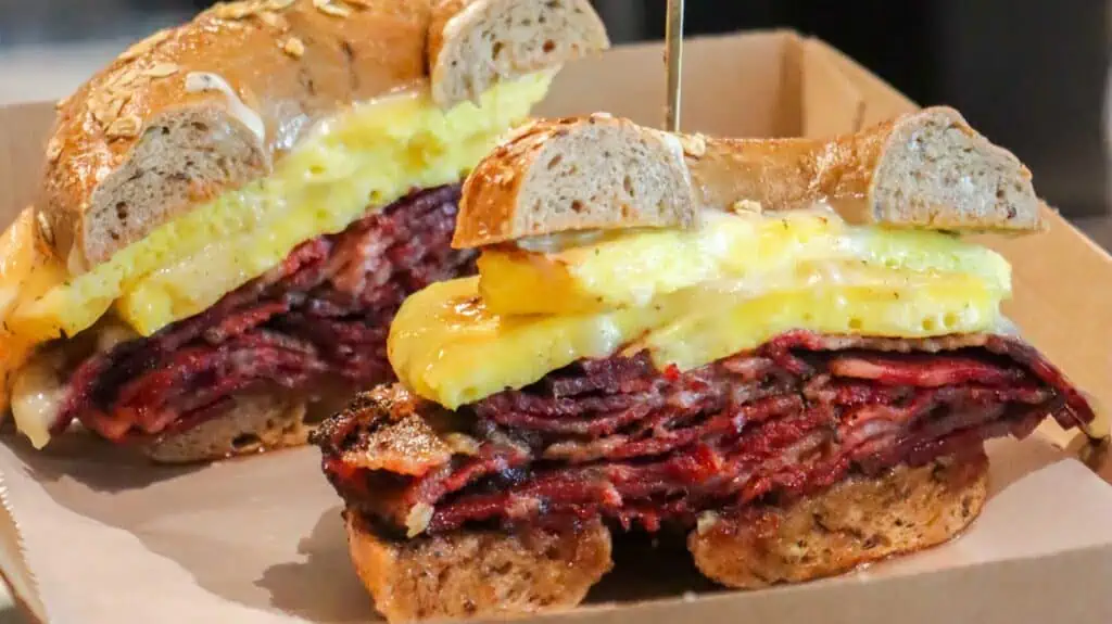 a bagel loaded with eggs and roast beef