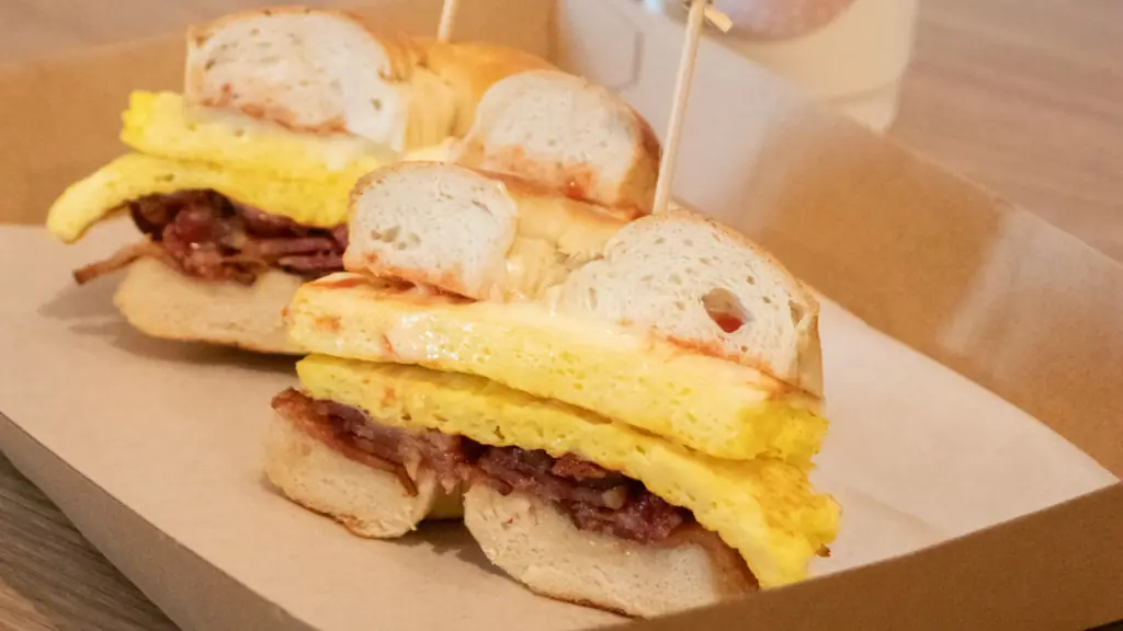 a bagel sandwich with eggs and sausage