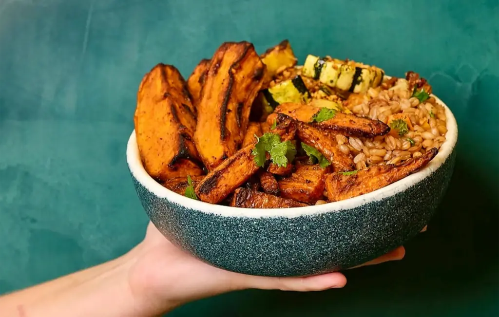 a harvest bowl filled with charred veggies