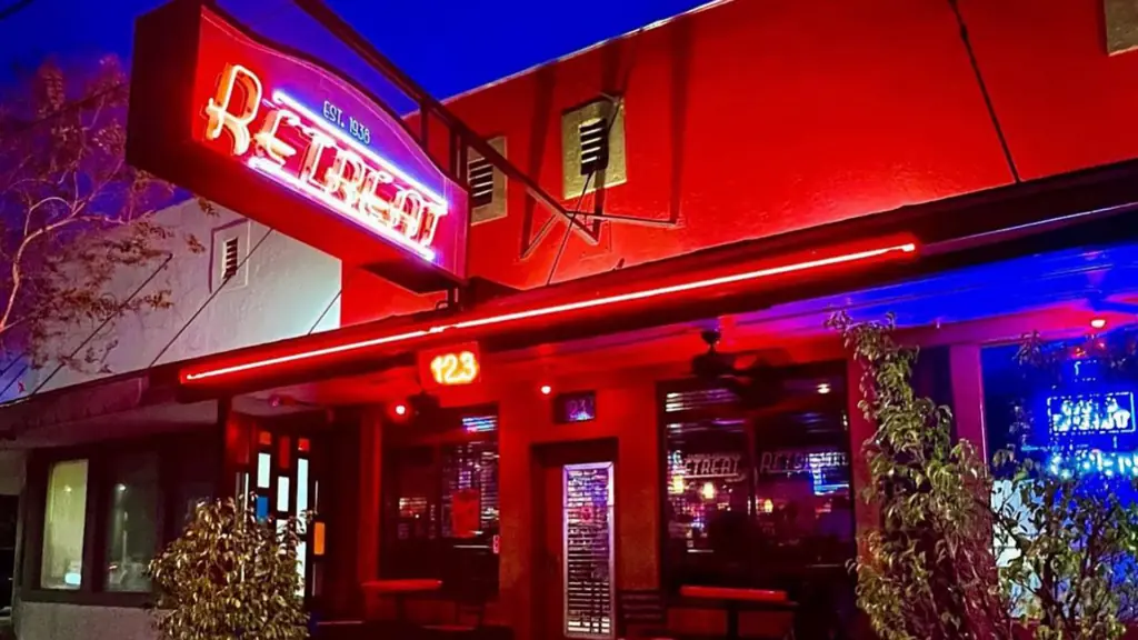 exterior of a bar with a neon sign