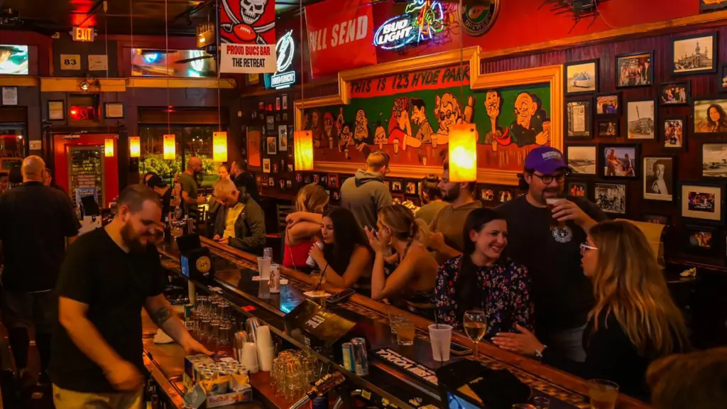 interior of a bar with tons of people approaching the bar