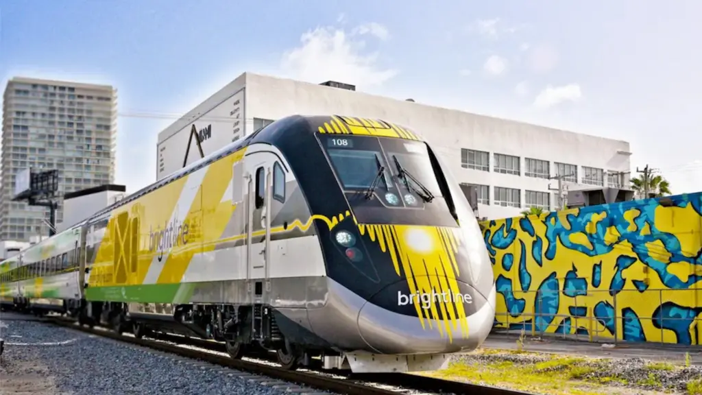 a train on the track with a yellow splash paint job