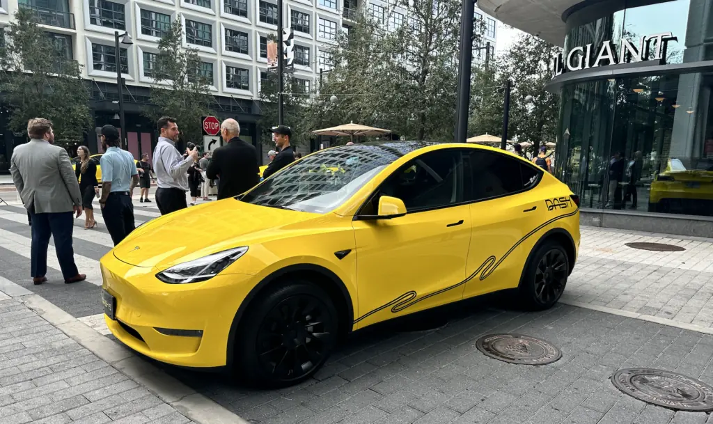 a yellow Tesla with the word DASH written on the side