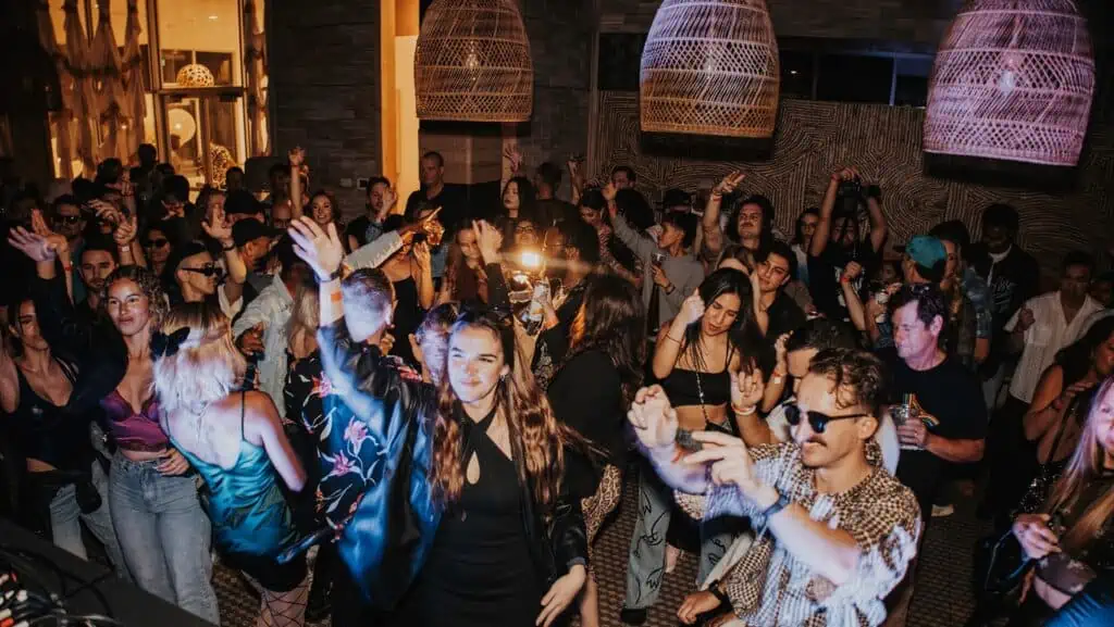 a group of people at a dance party on a rooftop venue