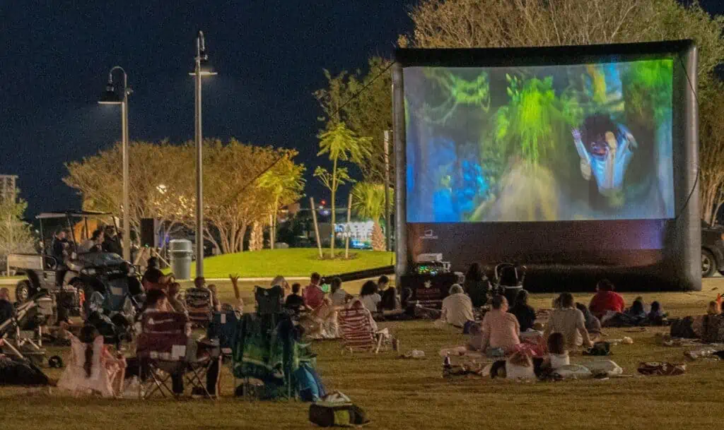 a large inflatable movie screen in a park