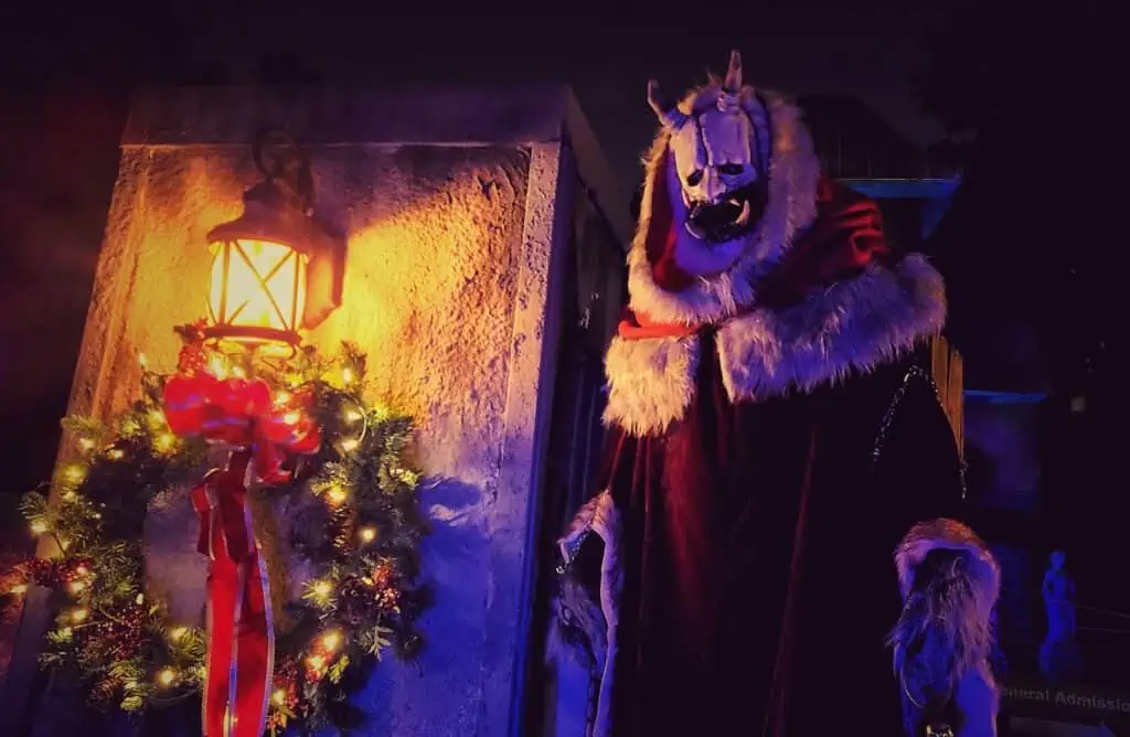 a large krampus looms over a haunted trail