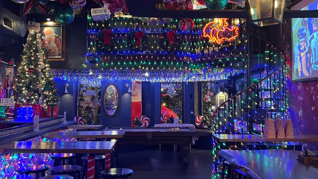 Christmas lights and decorations displayed inside a bar