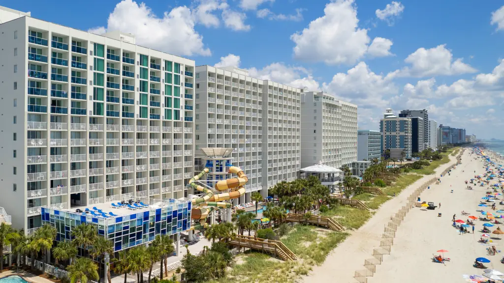 aerial view of a beach restore with colorful umbrellas set up on a beach