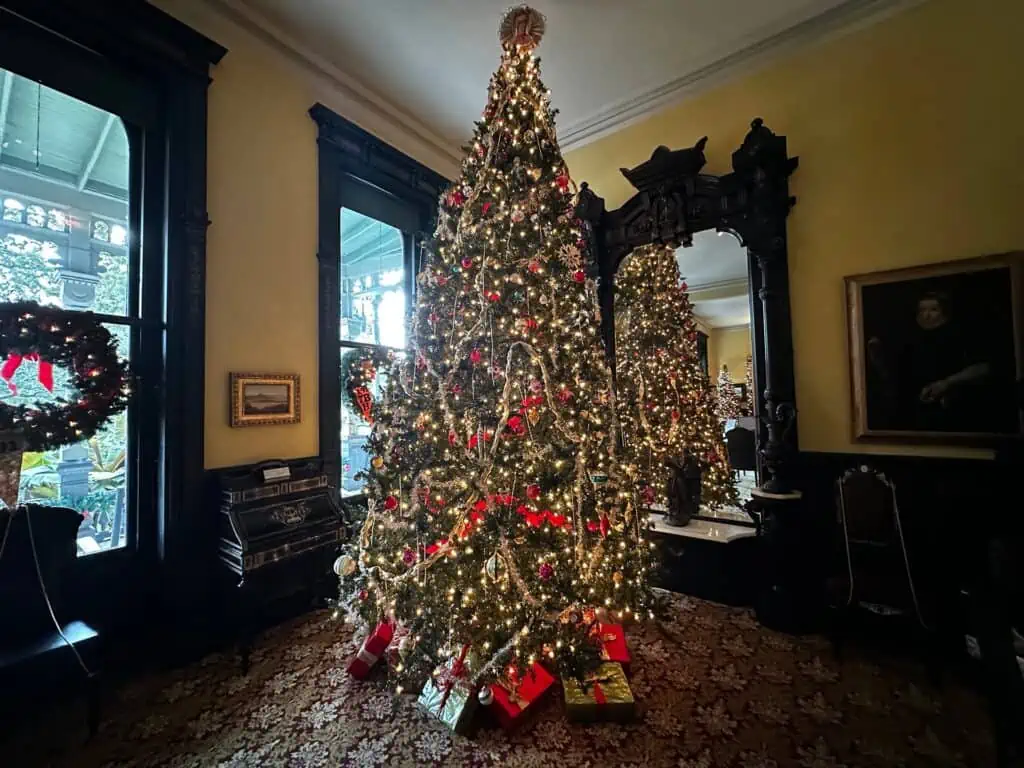 a christmas tree set up in a large ballroom