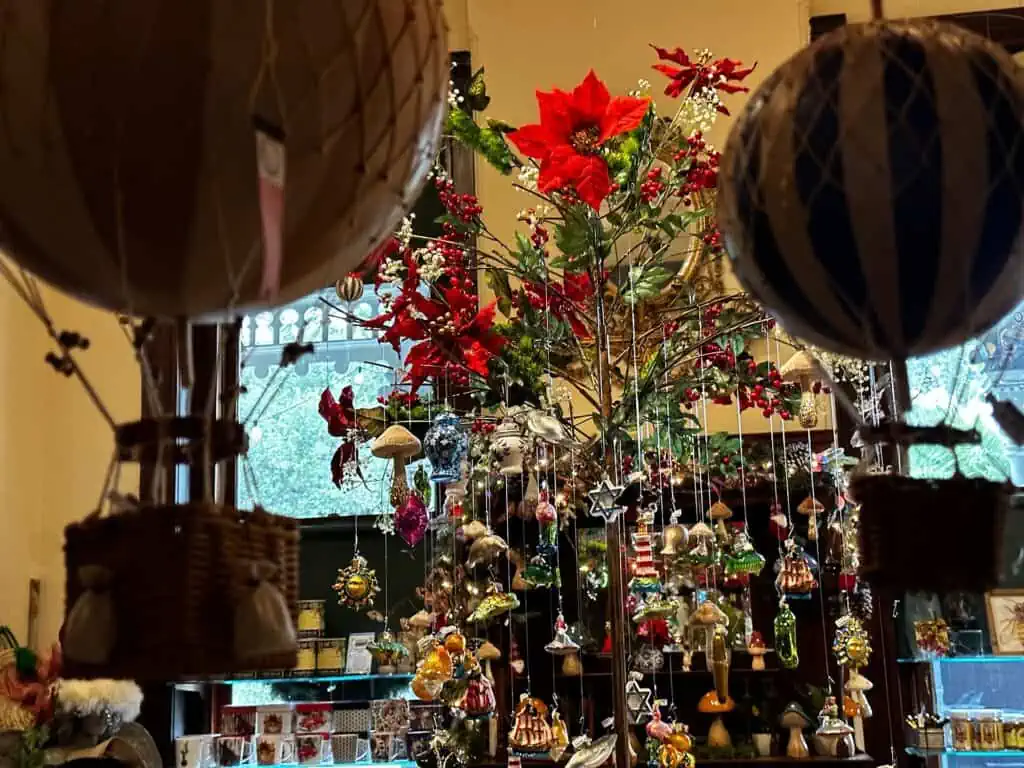 inside a gift shop with multiple ornaments on a tree