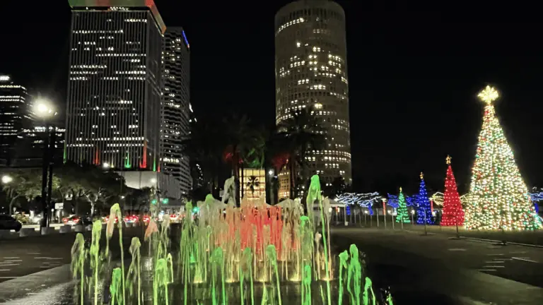 a colorful water fountain is lit up in red and green.