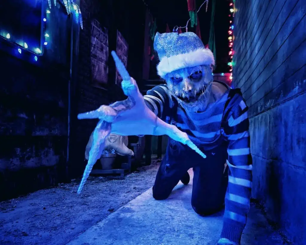 an evil frost elf reaches toward the camera with claws