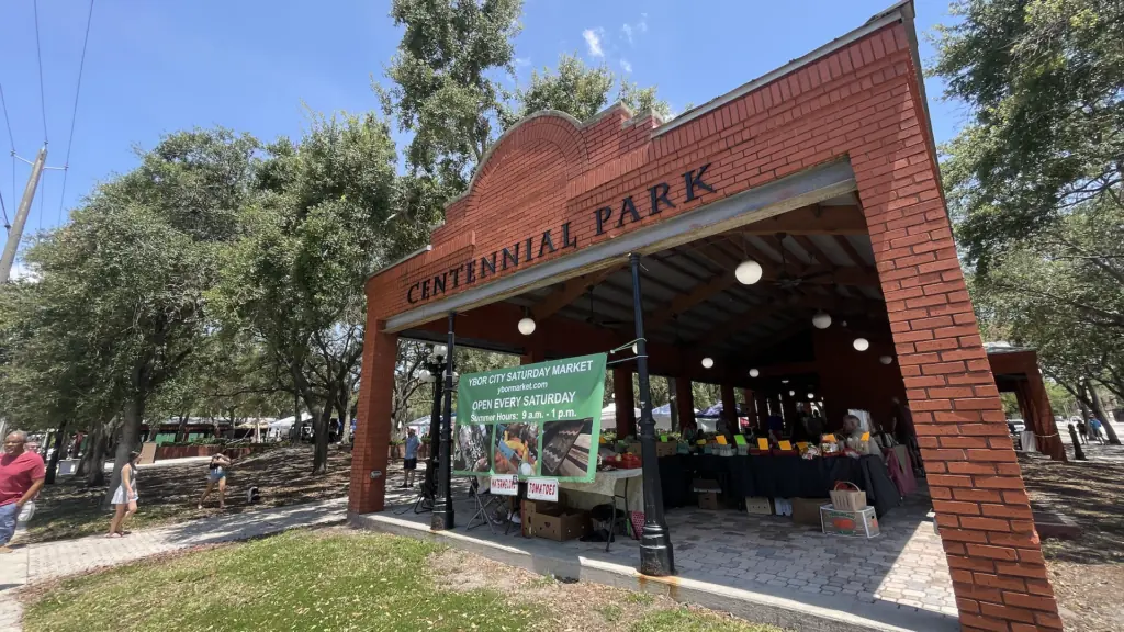 a park with a large brick shade structure