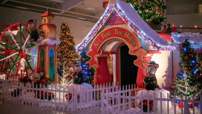 an illuminated gingerbread house within a Christmas village
