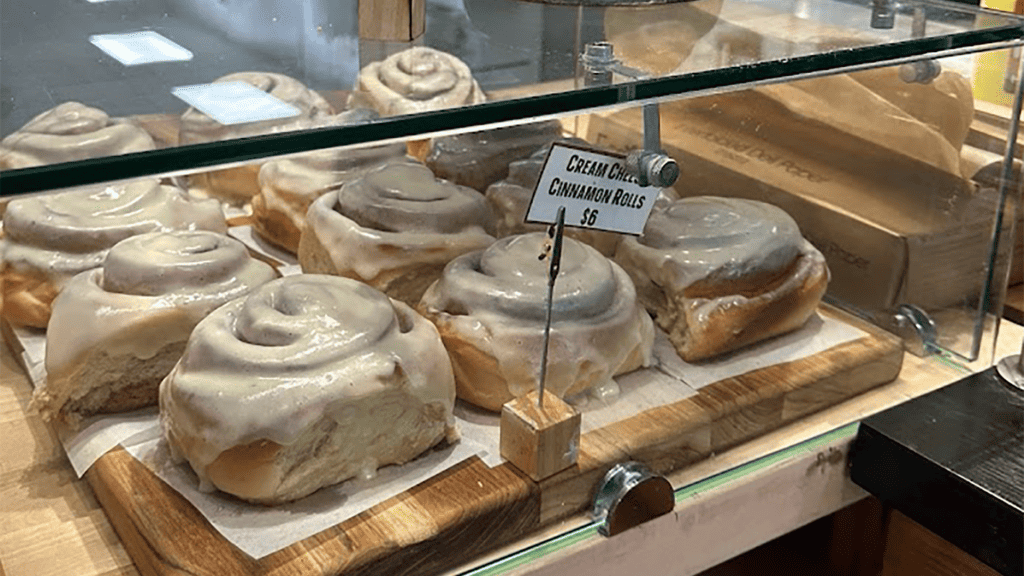 cinnamon rolls behind a pastry case