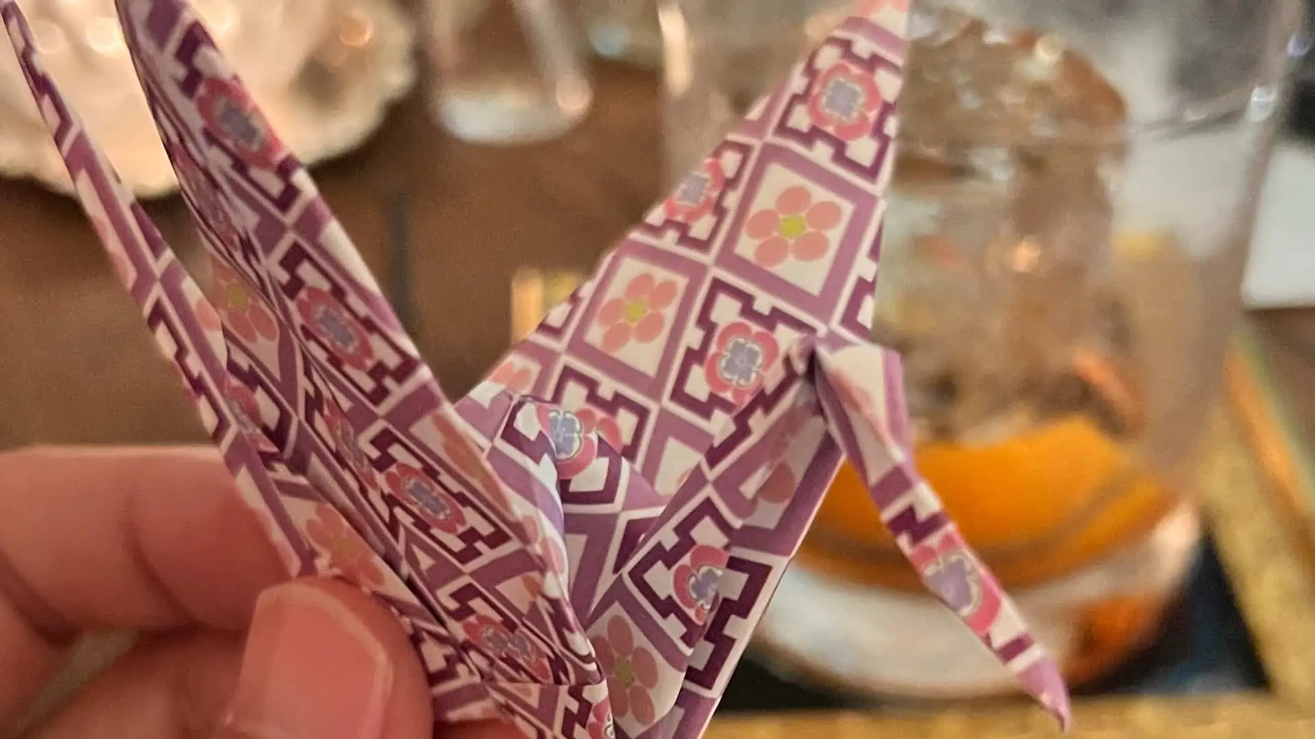 Origami of bird in front of a cocktail
