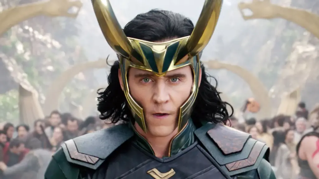 an actor wears a golden crown with two large horns on either side. He stares into the camera