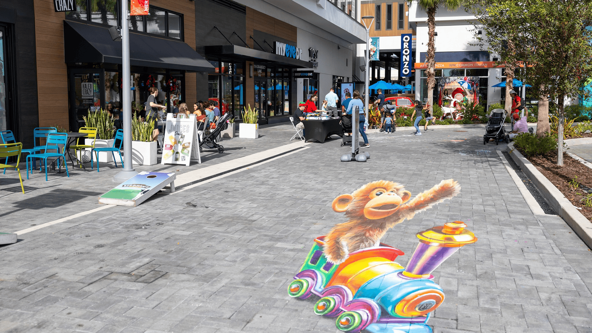 a market in a downtown area with chalk art on the sidewalk