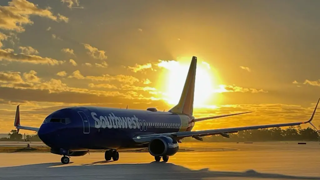 a plane on the runway at sunset