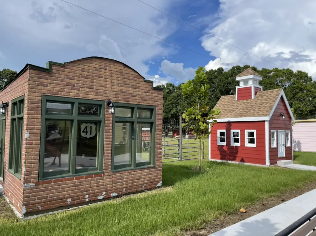 two tiny brick buildings on a farm designed to look like shops in a town