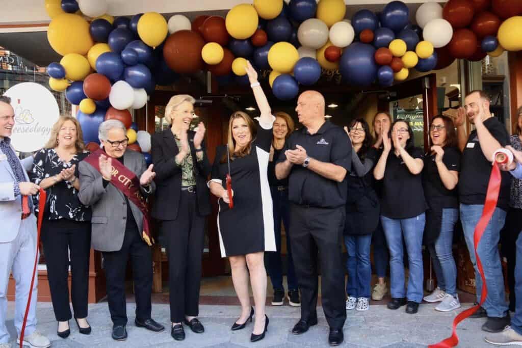 officials cut the ribbon on a new business in Ybor City