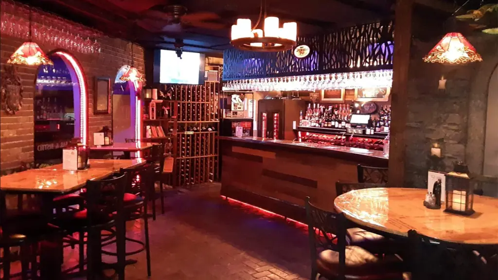 interior of a bar with a wall of wine in the corner