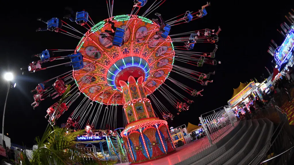 an illuminated swing ride at a carnival