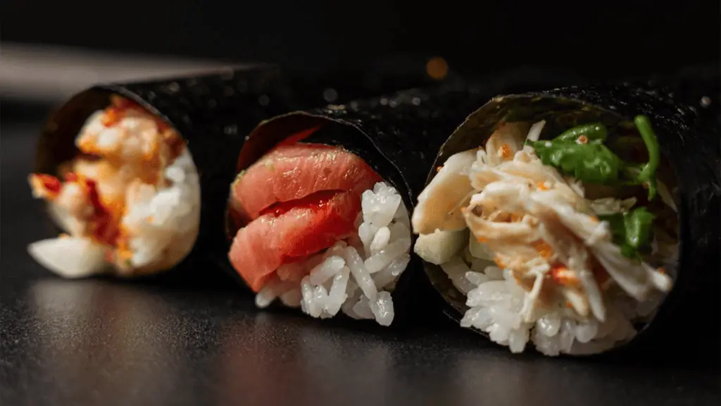 three hand roll sushi items from a restaurant