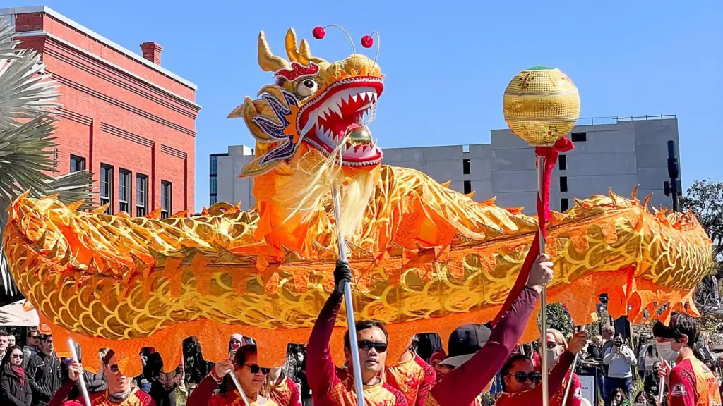 a large dragon held up by multiple performers