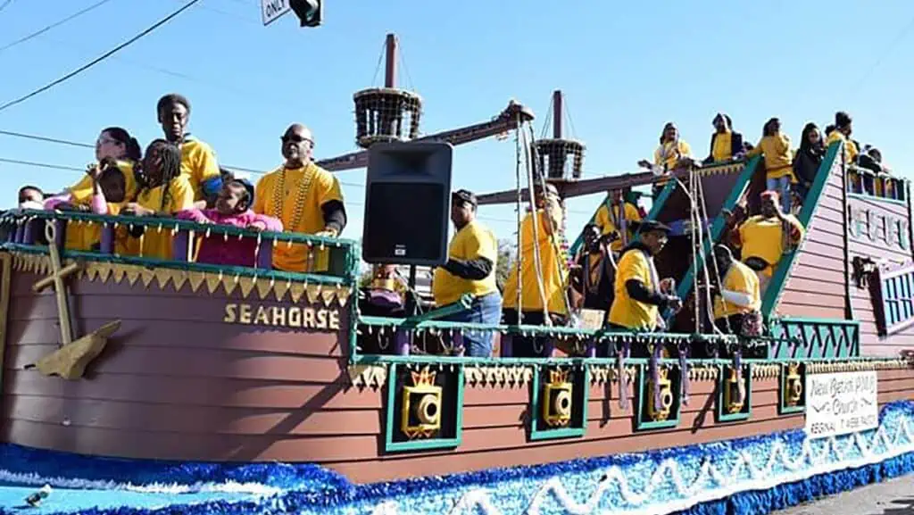 marching band members ride in a big pirate ship float