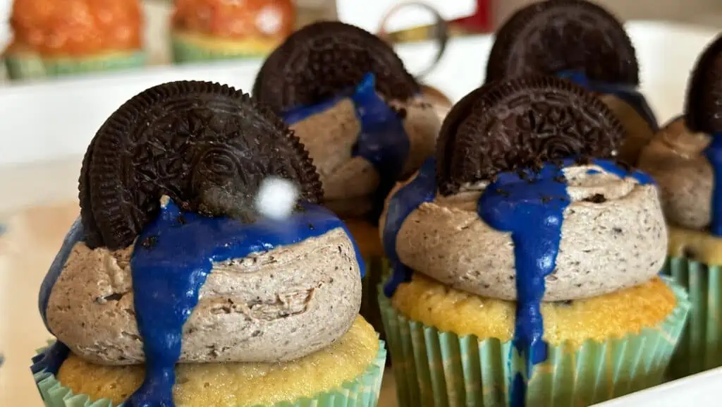 Oreo cookies sticking out of chocolate buttercream frosting on a cupcake