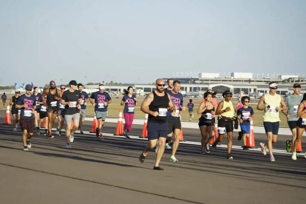 runners on a airport runway