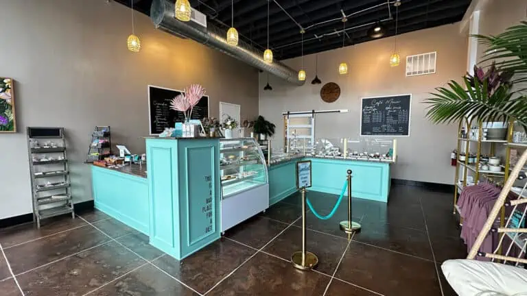 interior of a bakery with a blue counter and glass display cases