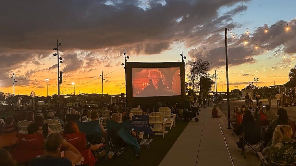 an outdoor film screening at sunset